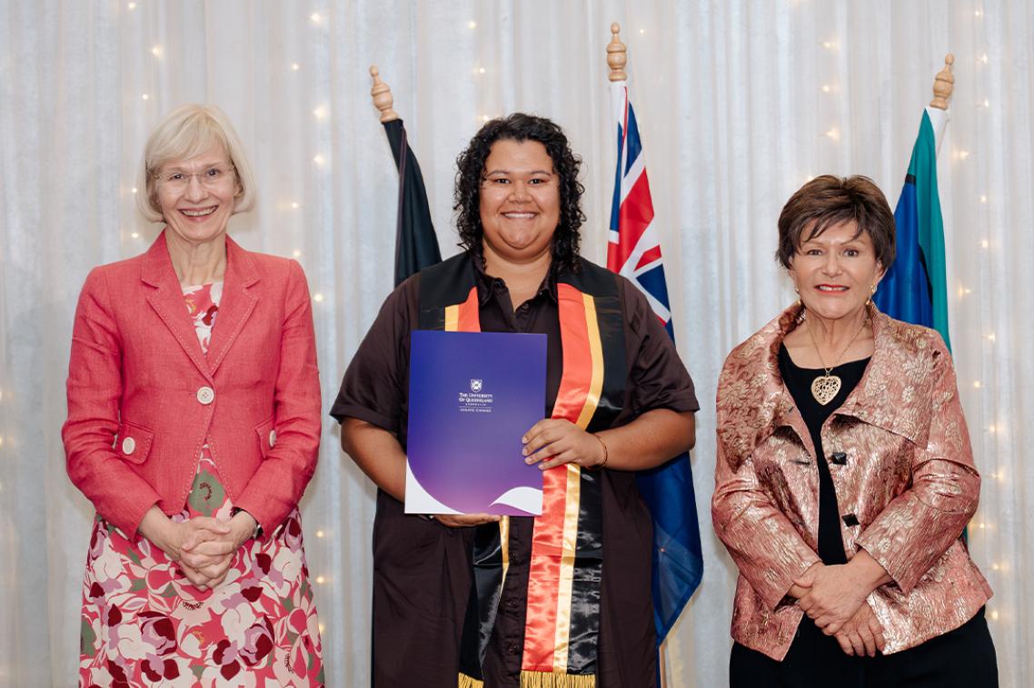 Dr Kate Thompson (centre) receiving her PhD with Vice-Chancellor Professor Deborah Terry (left) and Deputy Vice-Chancellor Indigenous Engagement Professor Bronwyn Fredericks (right).